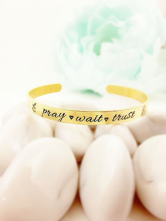 "Pray, wait, trust" brass bracelet.